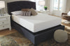 Colchón de Memory Foam tamaño Matrimonial sobre base tapizada gris oscuro con cabecera capitoné, en recámara con burós blancos, lámparas y tapete estampado - Estylo House Muebleria