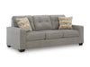 Sofá Cama Queen Storrow completo sobre fondo blanco, tapizado gris con cojines decorativos en estampado geométrico dorado - Estylo House Muebleria